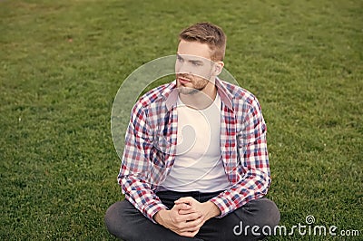 Good looking guy sit on green grass. Man unshaven face peaceful mood. Thinking about future. Existential crisis. Student Stock Photo