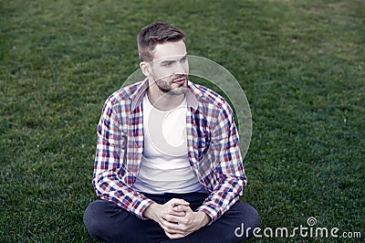 Good looking guy sit on green grass. Man unshaven face peaceful mood. Thinking about future. Existential crisis. Student Stock Photo