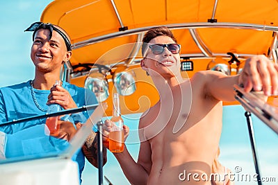 Good-looking male friends with bottles of soft drinks Stock Photo