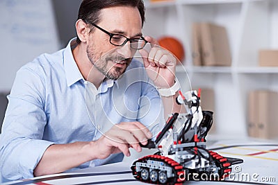 Good looking man performing measurements with a robot Stock Photo