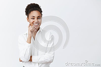 Good-looking successful dark-skinned female entrepreneur listening with polite and friendly smile employee, applying for Stock Photo