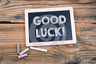 Good luck. blackboard and old wooden table Stock Photo