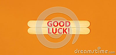 Good luck symbol. Concept words Good luck on wooden stick. Beautiful orange table orange background. Business, motivational good Stock Photo