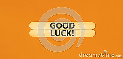 Good luck symbol. Concept words Good luck on wooden stick. Beautiful orange table orange background. Business, motivational good Stock Photo