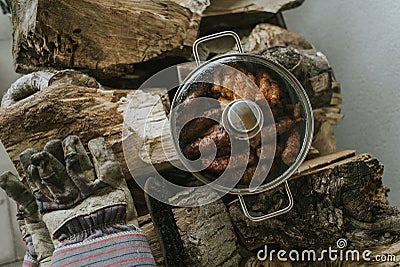 Good meal of roasted meat set on logs after a hard day`s work Stock Photo