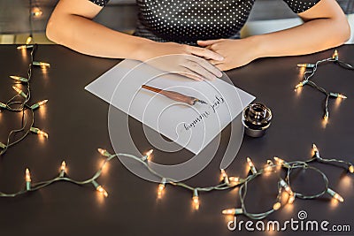 Good morning. Calligrapher Young Woman writes phrase on white paper. Inscribing ornamental decorated letters Stock Photo