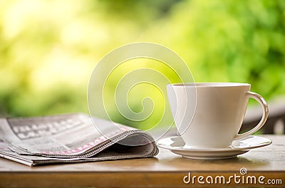 good morning coffee cup with news paper on nature green background in garden Stock Photo