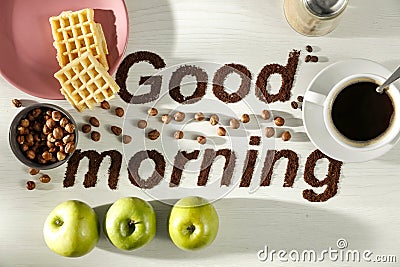 Good morning coffee grain beans inscription with bright table background. Copy space for advertising products and decoration. Stock Photo