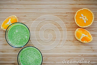 Good morning: Fresh green smoothies and fruits on wooden background, healthy breakfast. Text space Stock Photo