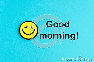 Good morning. Yellow emoticon on bright blue background Stock Photo