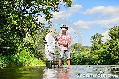 Good production. Fly fishing adventures. friends men with fishing rod and net. hobby of businessman. retirement fishery Stock Photo