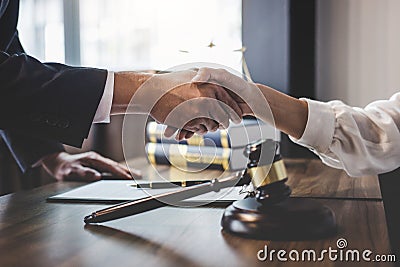 Good service cooperation of Consultation between a male lawyer and business woman customer, Handshake after good deal agreement, Stock Photo