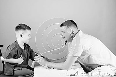 Good team. happy child with father with stethoscope. nurse laboratory assistant. family doctor. father and son in Stock Photo