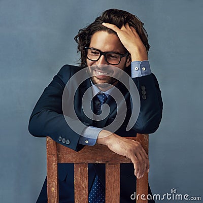 Good times on the mind. Studio shot of a well-dressed businessman against a grey background. Stock Photo