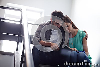 Good to have a shoulder to lean on. Shot of a man comforting a distressed woman in a stairwell. Stock Photo