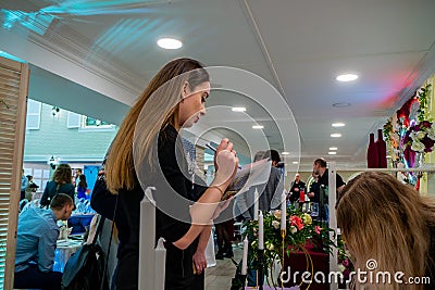 A lady checking a list at a wedding exhibition Editorial Stock Photo