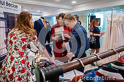 An engaged couple are making an order at a wedding exhibition Editorial Stock Photo