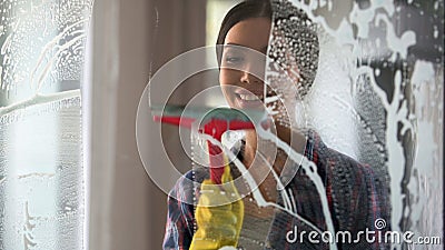 Good wife with pleasure cleaning house and washing room windows, order at home Stock Photo