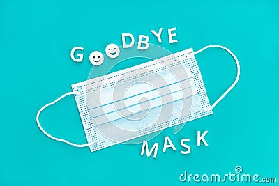 Goodbye mask phrase and face mask isolated on blue background Stock Photo