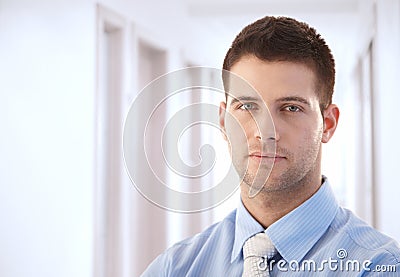 Goodlooking businessman standing in hallway Stock Photo