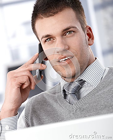 Goodlooking businessman talking on mobile phone Stock Photo