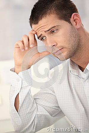 Goodlooking man having headache Stock Photo