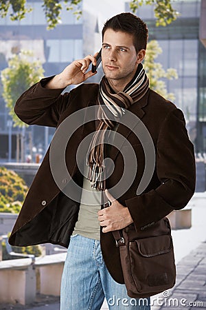 Goodlooking man on phone outdoors Stock Photo