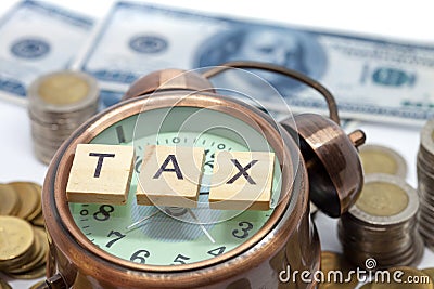 Goods and Services Tax word on Alarm clock and stacks coins Stock Photo