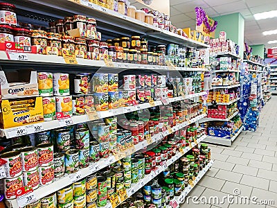 Goods on the shelf of a grocery store. Canned vegetables and fruit. Editorial Stock Photo