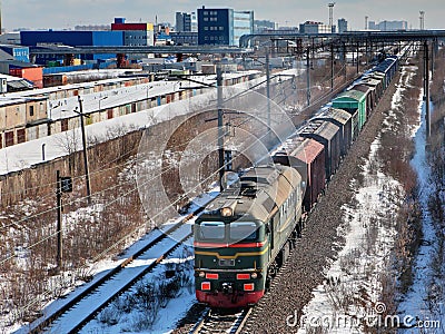Goods train carries cargo on railway track. Stock Photo
