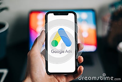 Google Ads logo on smartphone screen in hand Editorial Stock Photo