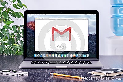 Google Gmail logo on Apple MacBook display in office workplace Editorial Stock Photo