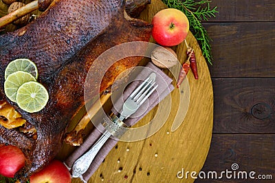 Goose baked in the oven with apples. Christmas goose on a wooden tray. Stock Photo