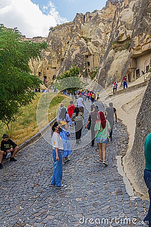 GOREME, TURKEY - JULY 19, 2019: Tourists visit Goreme open air museum in Cappadocia, Turk Editorial Stock Photo