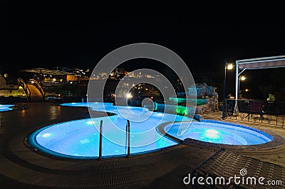 Picturesque night lights landscape of cave hotel in Goreme. Illuminated swimming-pool in the middle of terrasse. Editorial Stock Photo