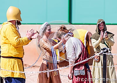 A beautiful lady who participates in the knight festival awards the winner of the fight in the lists in Goren park in Israel Editorial Stock Photo