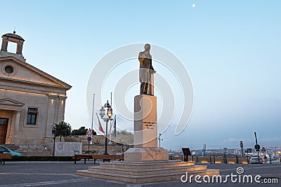 Gorg Borg Olivier statue with stock exchange building at Valletta Editorial Stock Photo