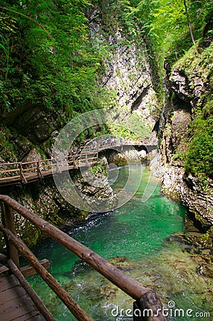 Gorge with a green river and wooden bridges Stock Photo