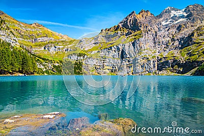 Gorgeous alpine lake with high mountains and glaciers, Oeschinensee, Switzerland Stock Photo