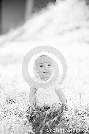 Gorgeous baby girl on a sunny meadow portrait Stock Photo