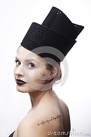 Gorgeous blonde woman model with blue eyes and black lipstick wearing big stylish designer black unique hat/ headpiece Stock Photo