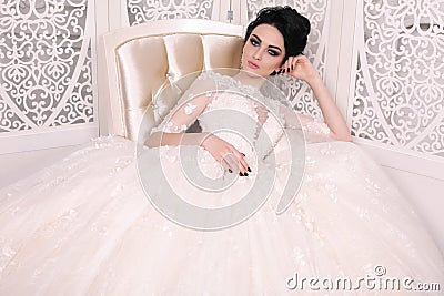 Gorgeous bride with dark hair in luxuious wedding dress Stock Photo