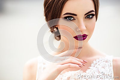 Gorgeous bride with fashion makeup and hairstyle in a luxury wedding dress Stock Photo