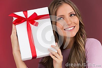 Gorgeous cute young woman holding present box Stock Photo