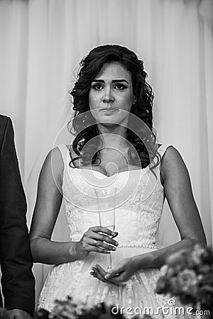 Gorgeous emotional brunette bride tearing up during a toast at w Stock Photo