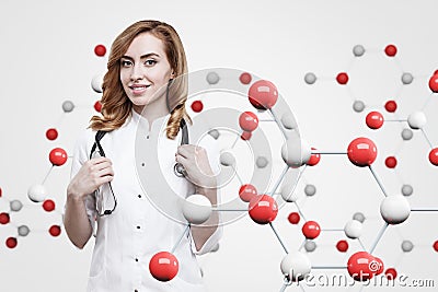 Gorgeous ginger doctor and an atom grid Stock Photo