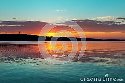 Gorgeous orange teal sunset on huge calm lake Stock Photo