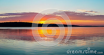 Gorgeous orange teal sunset on huge calm lake Stock Photo