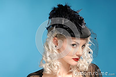 Gorgeous retro girl in forties hat with feathers Stock Photo