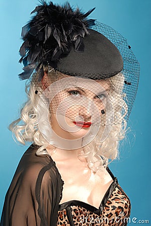 Gorgeous retro girl in forties hat with feathers Stock Photo